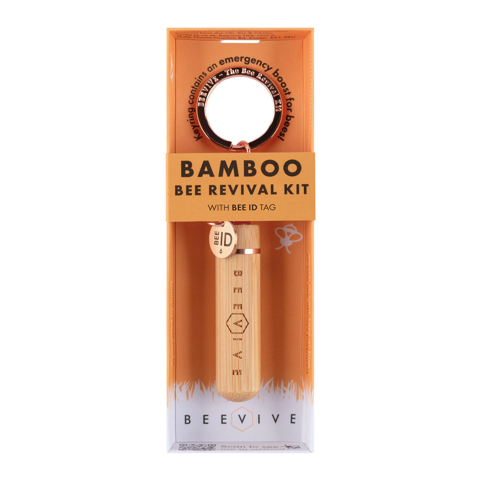 Bamboo Bee Revival Kit packaging with a wooden tool with rose gold trim and bee ID tag on an orange background.