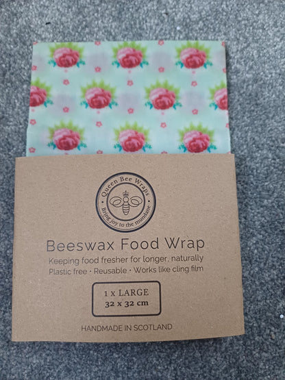 Beeswax food wrap with floral pattern and brown cardboard packaging on a gray surface