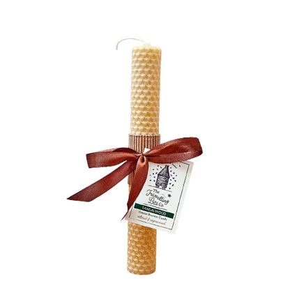 Beeswax candle with a brown ribbon and label on a white background
