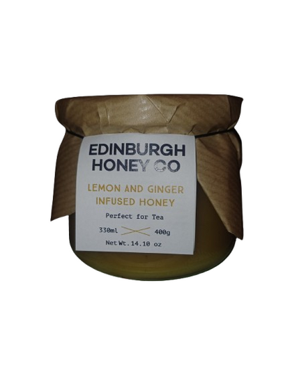 Jar of Edinburgh Honey Co lemon and ginger infused honey on a white background