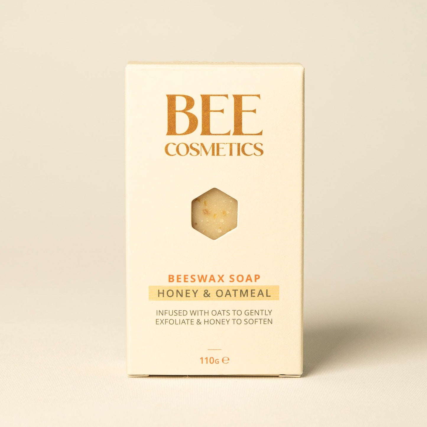 honey and oatmeal beeswax soap packaging with 'BEE Cosmetics' branding on a beige background