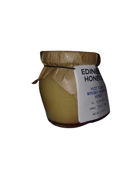 Jar of honey with a label on a white background