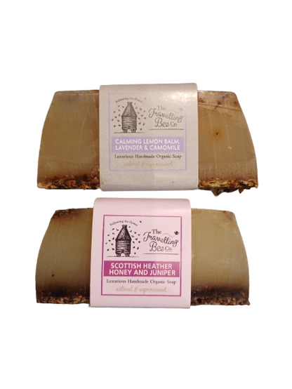Two bars of  handmade soap with labels on a white background