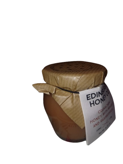 Jar of honey with a paper lid cover on a white background