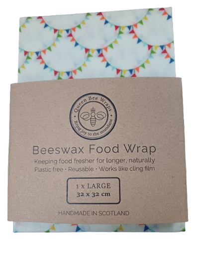 Beeswax food wrap with a cardboard packaging featuring Queen Bee Wraps branding.
