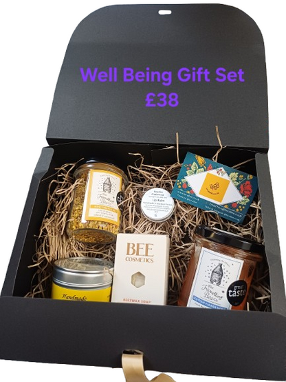 Well-being gift set with various items including candles and soap in a black box.