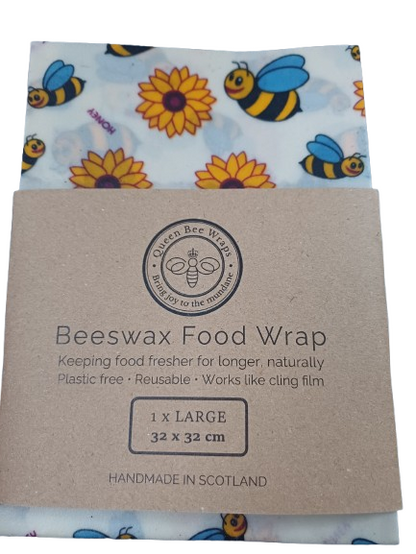 Beeswax food wrap with bee and flower pattern on a cardboard backing