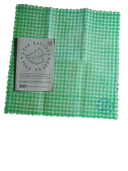 Green checkered beeswax food wrap with a Leaf Natural Food Wraps label on a white background